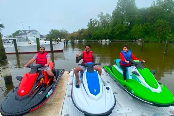 a group of people in a small boat in a body of water